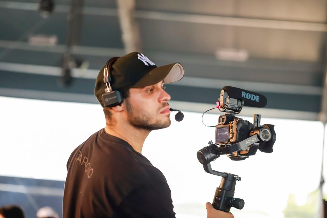 Juan filming with a gimbal and microphone at Surreal Park