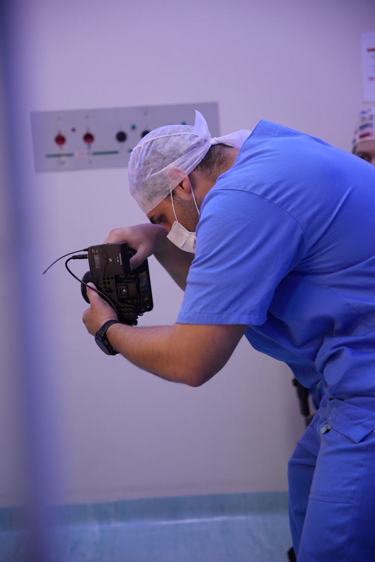 Juan wearing a surgical cap and mask at a clinic