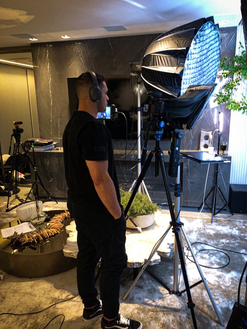 Juan setting up the lights on a film set