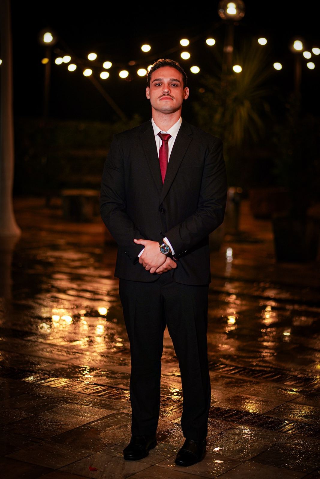 Portrait of Juan Ramirez in a suit, at night
